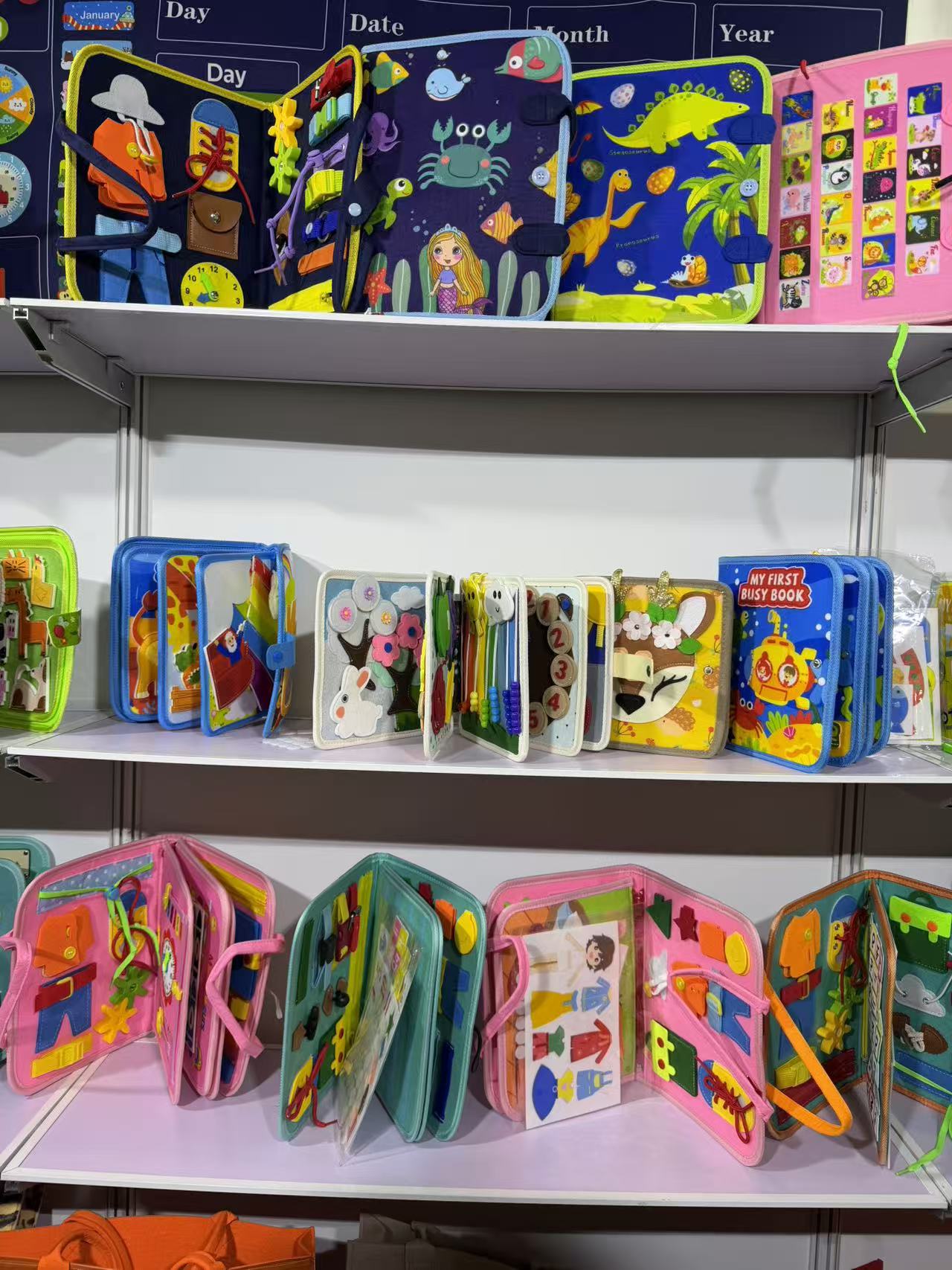 Busy books and early-learning fabric activity books at a supplier booth