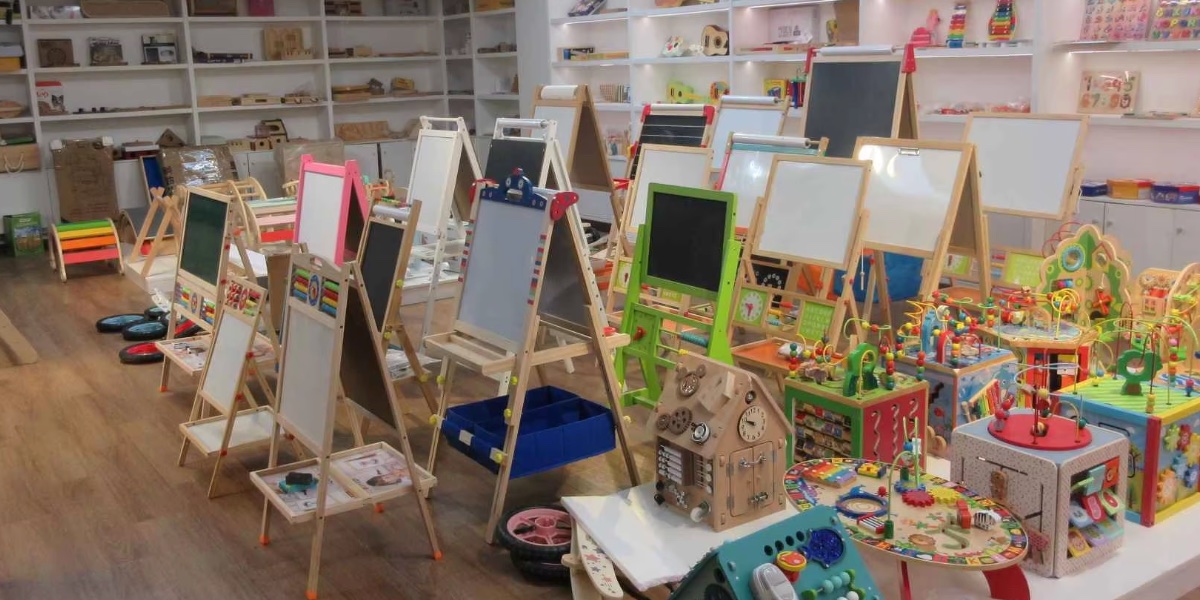 Supplier showroom displaying educational wooden toys, activity boards, and children product samples